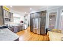 Modern kitchen featuring stainless steel appliances, custom cabinetry, and hardwood floors at 2440 Helena Moriah Rd, Timberlake, NC 27583