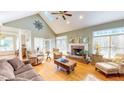 Cozy living room with a brick fireplace, vaulted ceiling, and ample natural light at 2440 Helena Moriah Rd, Timberlake, NC 27583