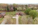 Sprawling property with a long drive, mature trees, and a charming brick home at 2563 Millbrook Dr, Haw River, NC 27258