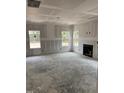 Spacious living room under construction featuring a fireplace and three large windows at 268 Dove Rd, Cameron, NC 28326