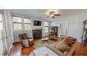 Cozy living room with hardwood floors, fireplace, and ample natural light at 308 College St, Oxford, NC 27565