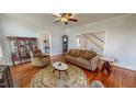 Inviting living room with hardwood floors, staircase, and vintage furnishings at 308 College St, Oxford, NC 27565