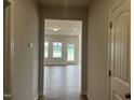 Bright hallway leads to a light-filled living area, showcasing the open layout of the home at 34 E American Marigold Dr # 64, Benson, NC 27504