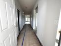 Bright hallway featuring white doors, neutral walls, and a glimpse of the living space at 34 E American Marigold Dr # 64, Benson, NC 27504