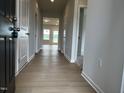 Inviting hallway featuring wood floors and neutral paint, providing a warm welcome at 34 E American Marigold Dr # 64, Benson, NC 27504