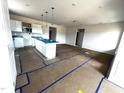 Spacious kitchen area featuring white cabinets and a central island with pendant lights at 34 E American Marigold Dr # 64, Benson, NC 27504