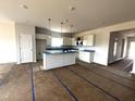Open-concept kitchen featuring an island, white cabinetry, and recessed lighting at 34 E American Marigold Dr # 64, Benson, NC 27504