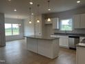 Modern kitchen with granite countertops, stainless steel appliances, and a spacious island at 34 E American Marigold Dr # 64, Benson, NC 27504