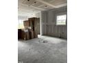 Spacious unfinished room showing drywall, concrete flooring, and boxed materials at 34 E American Marigold Dr # 64, Benson, NC 27504