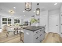 A bright, open-concept kitchen with stainless steel appliances and a center island offers a welcoming space at 364 Church St, Morrisville, NC 27560