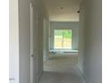 Bright hallway featuring sliding glass doors leading to the outdoor space at 39 Atherton Circle, Angier, NC 27501