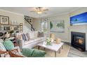Comfortable living room with stylish decor, fireplace, ceiling fan, and view of staircase at 39 Atherton Circle, Angier, NC 27501