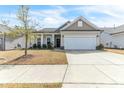 Welcoming home with a two-car garage, a well-cared for lawn, and carefully placed plants at 4102 Catfish Way, Durham, NC 27703