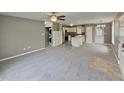Expansive living room open to kitchen with neutral tones and carpet throughout at 414 Longfellow St, Fuquay Varina, NC 27526