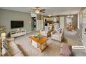 Bright living room open to kitchen and dining with ceiling fan, neutral tones and ample seating at 414 Longfellow St, Fuquay Varina, NC 27526