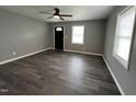 Modern living room featuring neutral paint, contemporary ceiling fan, and stylish flooring at 427 Elm Ct, Burlington, NC 27215
