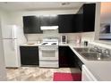 Modern kitchen with ample cabinet space, new appliances, and a stylish red rug at 4907 Hollenden Dr # 105, Raleigh, NC 27616