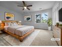 Bright bedroom features a wooden bed frame, a ceiling fan and a window view at 5620 Hamstead Xing, Raleigh, NC 27612