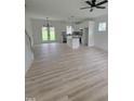 Bright living room showcases an island kitchen, wood floors, and outdoor access at 5710 Russell Rd, Durham, NC 27712