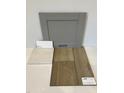Close up view of color selection samples including cabinets, backsplash and luxury vinyl flooring at 62 Atherton Circle, Angier, NC 27501