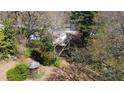 An aerial view showcasing the home's setting amongst mature trees and a quaint gazebo in the yard at 620 Sunnybrook Rd, Raleigh, NC 27610
