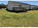 Spacious backyard featuring a wooden deck, perfect for outdoor relaxation and entertaining at 70 Ariel St, Lillington, NC 27546