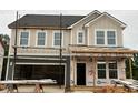Charming two-story home with an attached two-car garage, showcasing a modern design and inviting curb appeal at 766 Old Station Pointe, Angier, NC 27501
