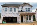 New two-story home under construction features an attached garage and a covered front porch at 766 Old Station Pointe, Angier, NC 27501
