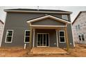 Covered patio view with grey siding and white trim, providing a perfect spot for outdoor relaxation at 766 Old Station Pointe, Angier, NC 27501