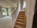 Staircase under construction with wood stairs and natural light at 766 Old Station Pointe, Angier, NC 27501
