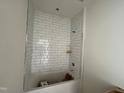 A bathtub with white subway tile surround and built-in shelving, offering a clean and modern aesthetic at 771 Old Station Pointe, Angier, NC 27501