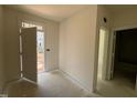 A well-lit mudroom with neutral walls, a door to the outside, and an additional doorway leading into another room at 771 Old Station Pointe, Angier, NC 27501