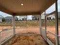 The screened porch has an outdoor space with views of the surrounding neighborhood at 771 Old Station Pointe, Angier, NC 27501