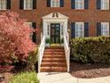 Welcoming front entrance with brick steps, black door, and classic architectural details at 8000 N Bridgewater Ct, Raleigh, NC 27615