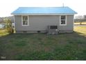 Rear exterior of home with light gray siding, white trim, and a newer HVAC system at 912 Martin Luther King Jr Dr, Smithfield, NC 27577