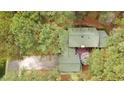 A bird's eye view reveals this home's layout with a spacious driveway and outdoor deck, surrounded by verdant foliage at 917 Queensferry Rd, Cary, NC 27511