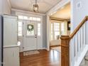Bright foyer with hardwood floors, white trim, and a view into the adjacent living spaces at 921 Marshall Farm St, Wake Forest, NC 27587