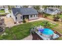 Aerial view of backyard featuring an above ground pool, a landscaped yard, and a screened in back porch at 97 Silver Creek Dr, Clayton, NC 27520