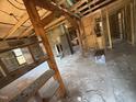 Interior view of home under renovation with exposed beams and studs at 1005 Chatham St, Sanford, NC 27330