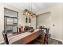 Beautiful dining room with a decorative light fixture, hardwood floors, and easy access to the kitchen at 103 Glenview Ln, Durham, NC 27703