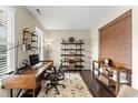 Cozy home office featuring a wooden desk, comfortable chair, natural light, and hardwood floors at 103 Glenview Ln, Durham, NC 27703