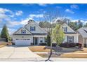 Inviting single-story home featuring a well-maintained lawn, a two-car garage, and a welcoming entrance at 1038 Branwell Dr, Durham, NC 27703