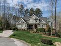 Stylish home with a manicured lawn and detailed landscaping around the front entrance at 107 Bella Casa Way, Clayton, NC 27527