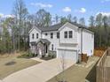 Charming two-story home boasts white siding, stone accents, well-manicured landscaping, and an attached two-car garage at 111 Kim Bark Path, Garner, NC 27529