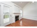 Bright living room with hardwood floors, fireplace, built-in cabinets, and access to outdoor deck at 114 Hudson Dr, Princeton, NC 27569