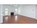 Spacious living room with hardwood floors, fireplace, vaulted ceilings, and lots of natural light at 114 Hudson Dr, Princeton, NC 27569