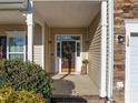 Inviting entryway with a decorated brown door, sidelights, and stone accents around the two-car garage at 120 Wellspring Dr, Holly Springs, NC 27540