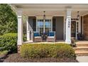 Cozy front porch featuring comfortable seating and decorative plants, perfect for relaxing outdoors at 1204 Croydon Glen Ct, Cary, NC 27519