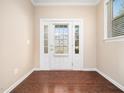 Inviting foyer featuring hardwood floors and a charming front door with sidelights at 1220 Falcon Ridge Ln, Morrisville, NC 27560