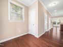 Hallway showcasing hardwood floors, neutral walls and white doors in a bright, inviting space at 1220 Falcon Ridge Ln, Morrisville, NC 27560